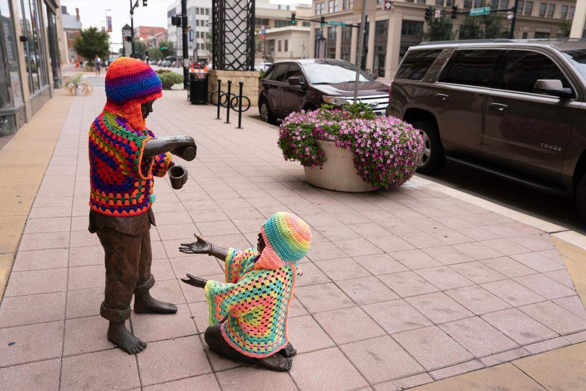 The two kids playing at Douglas and Broadway also got new clothes from crochet artist Tamara Gonzales.
