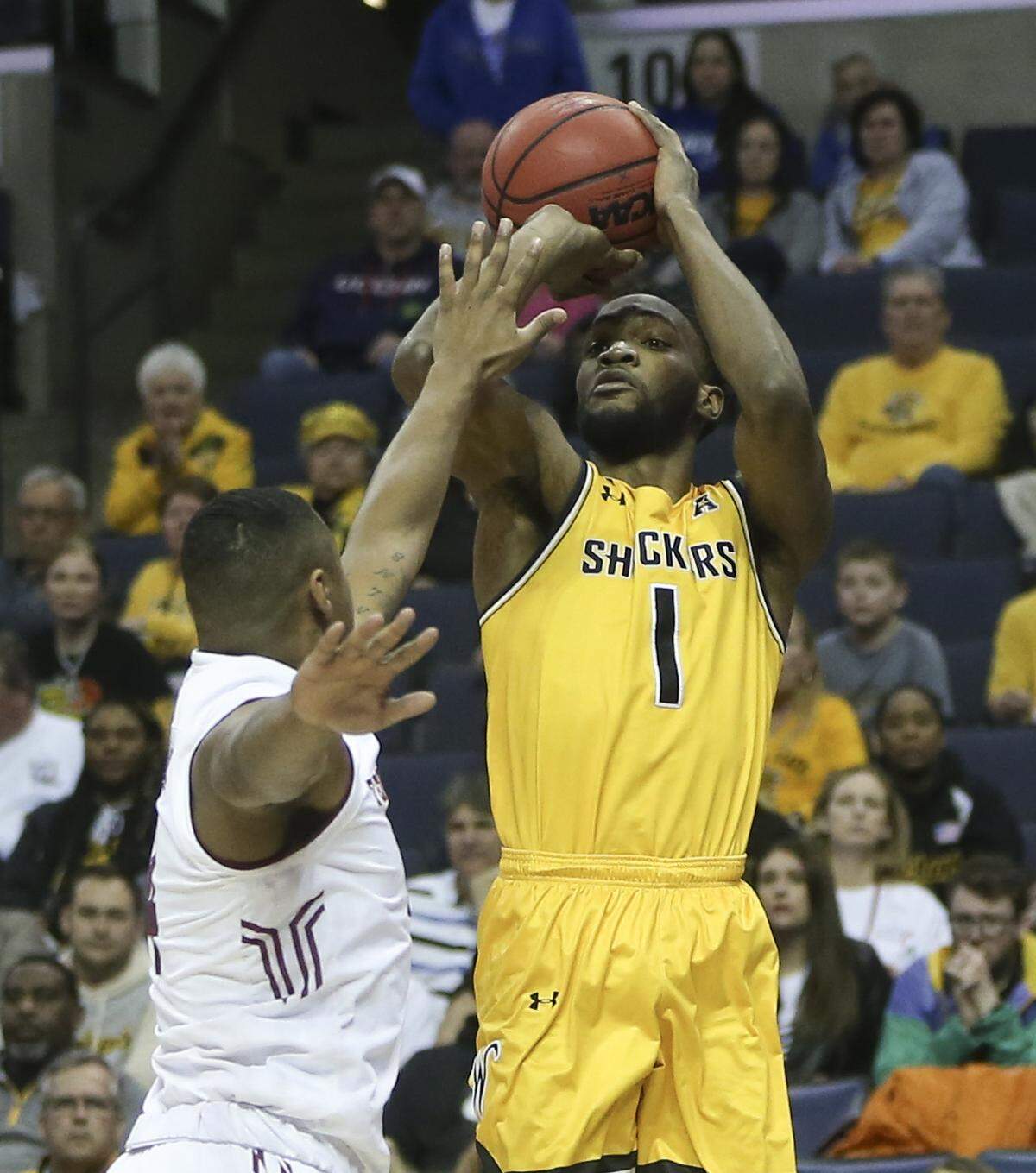 Wichita State forward Markis McDuffie shoots a three-pointer over Temple forward J.P. Moorman II during the first half of their American Athletic Conference quarterfinal game in Memphis on Friday.
