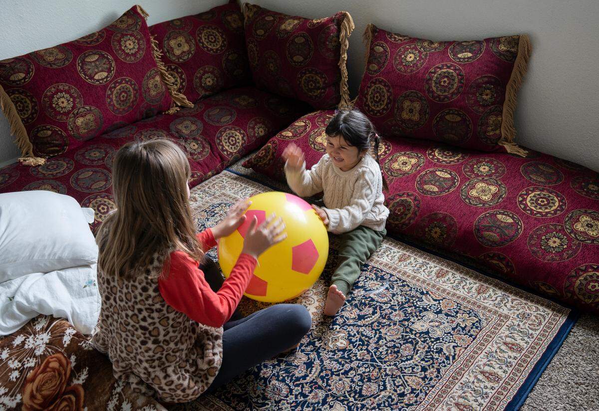 Halima Alakozai, 5, plays with Haddie Satrom, the daughter of Crystal Satrom who is teaching English to the Alakozai family. (May 21, 2022)