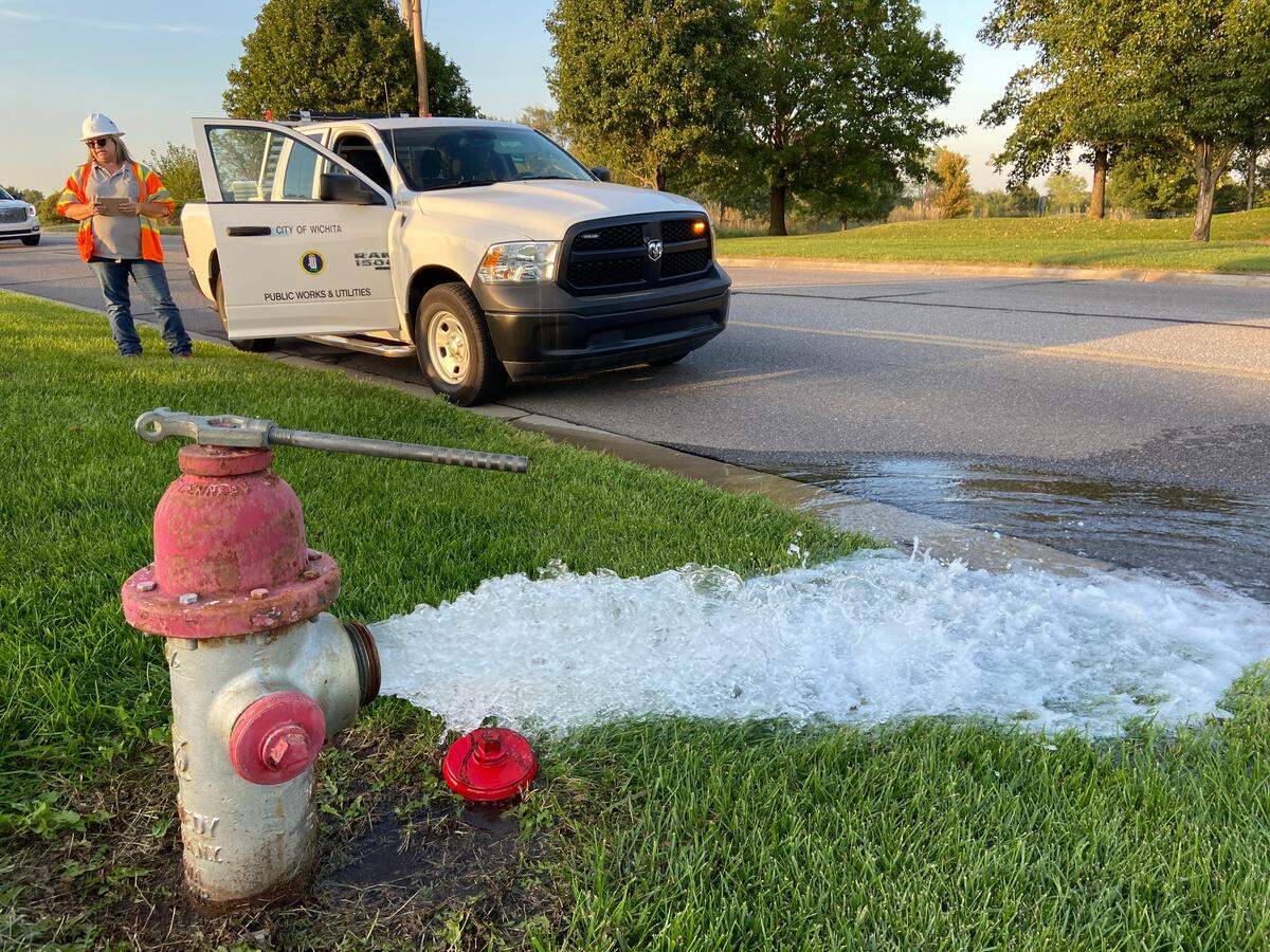 Wichita Public Works employees are flushing water lines throughout the city. This is in front of the Auburn Hills Golf Course on 135th St. W. on Thursday evening.