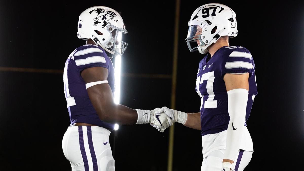 Kansas State football players Felix Anudike-Uzomah and Nate Matlack model alternate uniforms.