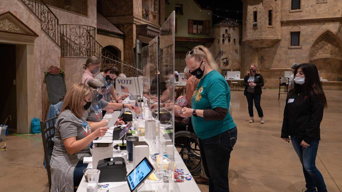 Voters check in cast their votes inside the St Vincent de Paul Church in Andover Tuesday, Nov. 3, 2020..