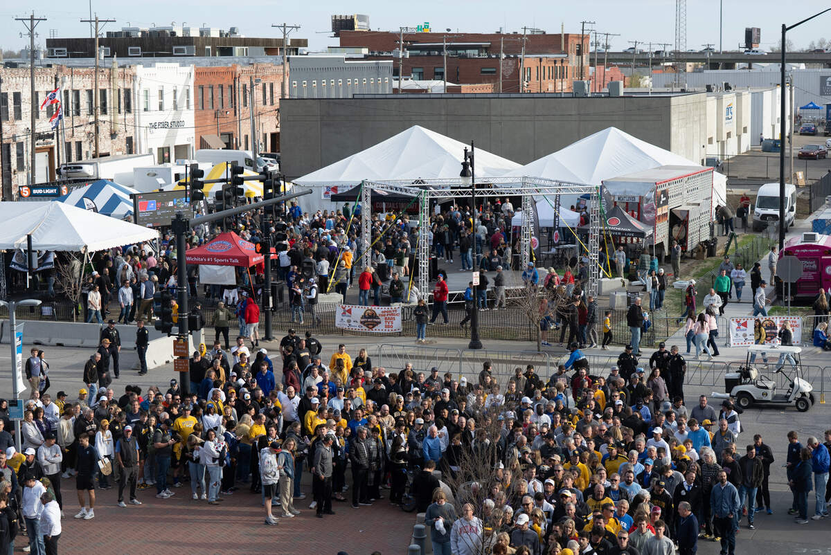 Folks line up to enter Intrust Bank Arena to watch the second set of two games in the first round of the 2025 NCAA Division I Men’s Basketball Championship