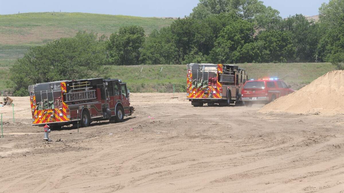 A 52-year-old construction worker died after his bulldozer rolled backward into a man-made pond at a housing development in north Wichita. This photo shows fire trucks on the scene of the accident.