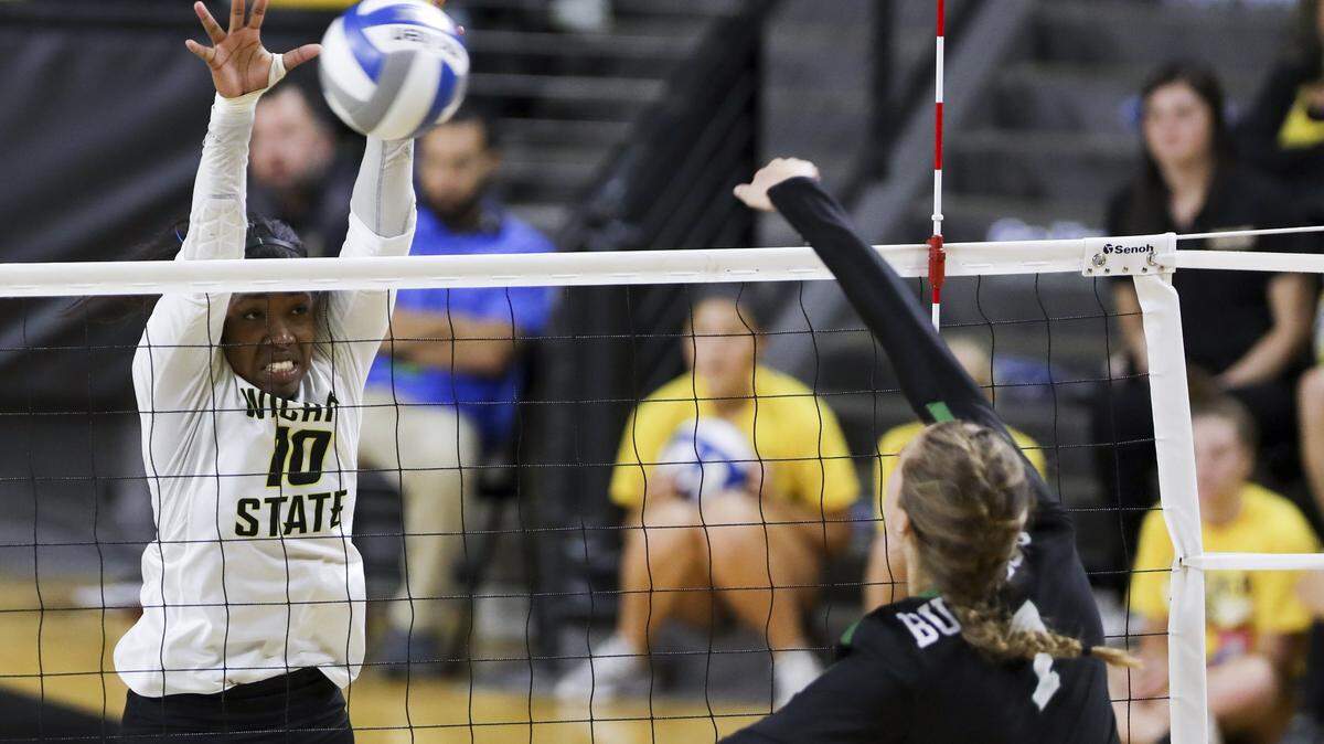Wichita State outside hitter Tabitha Brown goes up against  Tulane outside hitter Yvette Burcescu during the home-opener in Koch Arena. (Sept. 21, 2018)