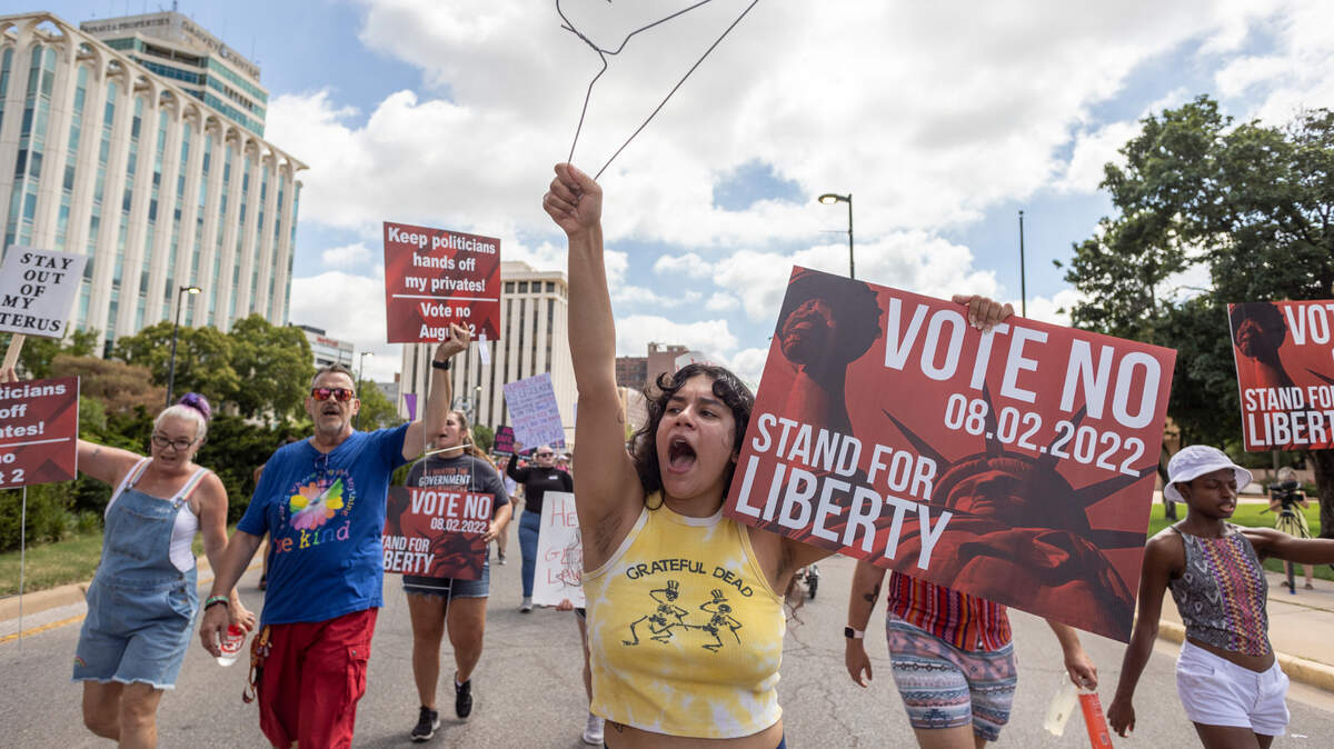 Emmy Rodriguez and other demonstrators urge a “no” vote on a Kansas constitutional amendment that would empower the Legislature to ban abortions. The vote could have been held during a general election in 2020, or this year, but Republican lawmakers insisted it be on a primary ballot where turnout usually favors conservatives.