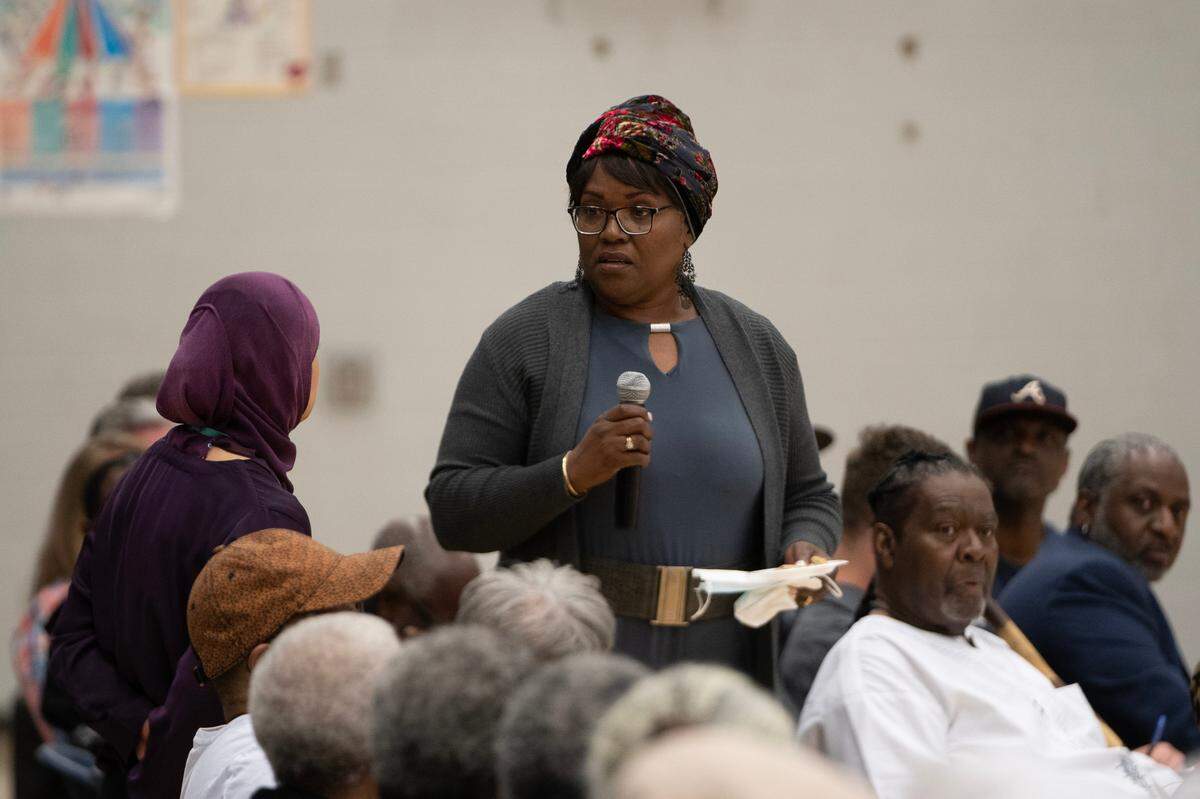 Marie Florence asks a question during a public meeting Friday night at the Boys and Girls Club, 2400 N. Opportunity Drive. Florence’s husband’s family has lived in the area for 60 years and she said several family members had had cancer.
