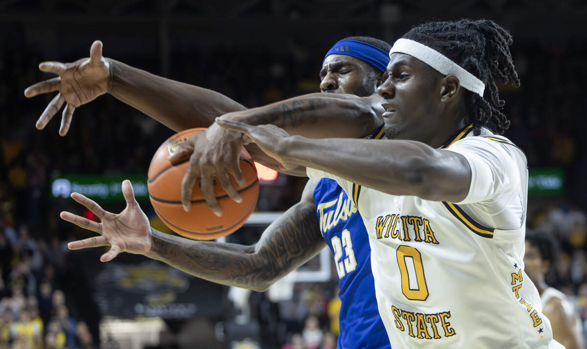 Wichita State’s Karon Boyd fights Tulsa’s David Green for a loose ball during the second half at Koch Arena on Saturday night.