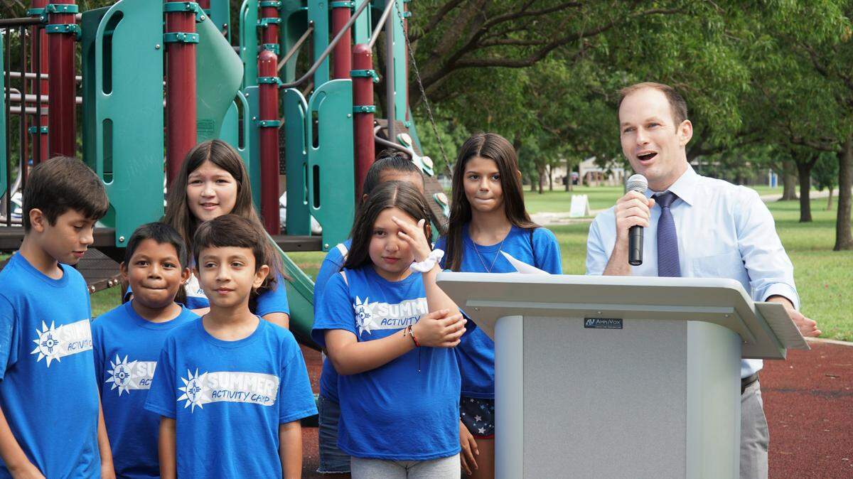 Mayor Brandon Whipple at the podium introduces Wichita’s first permanent story walk on Wednesday morning. The story walk is located throughout the walking trail at Evergreen Park in north Wichita.