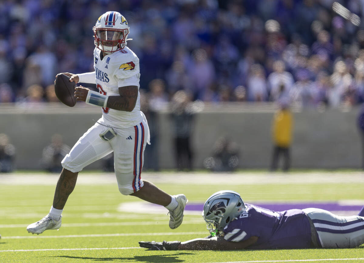 Kansas quarterback Isaiah Marshall scrambles while looking for receiver downfield during the secondt half of their game against Kansas State in Manhattan on Saturday.