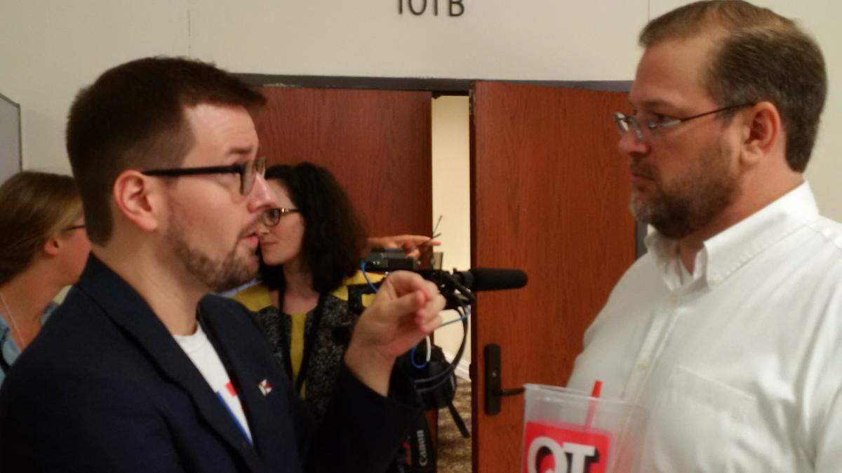 Congressional candidate James Thompson, right, talks with aide Chris Pumpelly before Bernie Sanders rally.