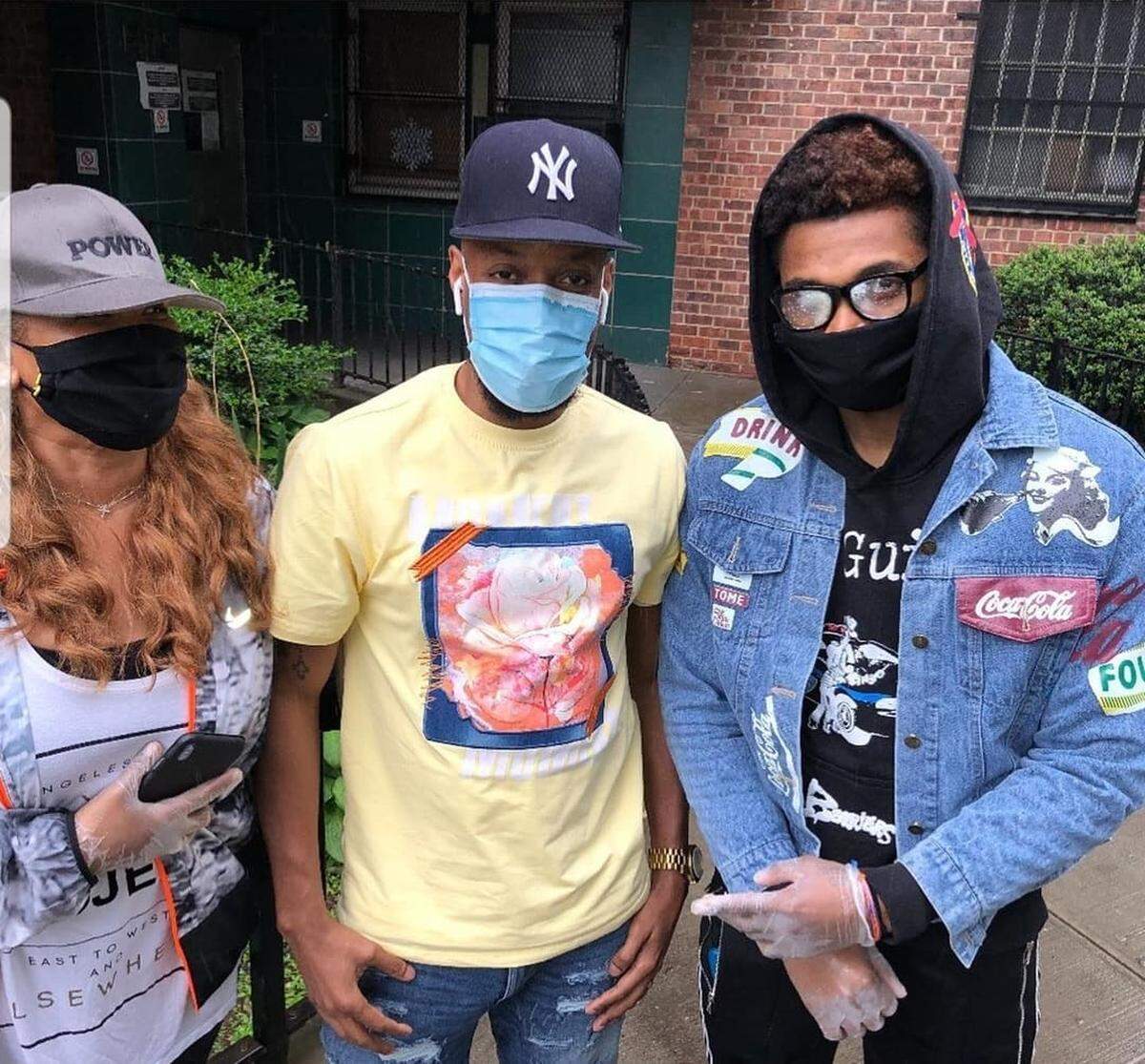 Tyson Etienne (right) poses with his former basketball coach Shaun Commodore (middle) and his mother, Anita Gibson (left), at the fundraiser that Etienne helped organize in East Harlem.