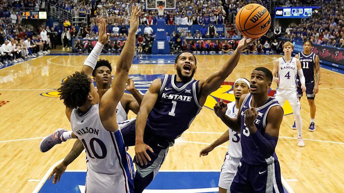 Kansas State guard Markquis Nowell (1) gets past Kansas forward Jalen Wilson (10) to put up a shot during the second half of an NCAA college basketball game Tuesday, Jan. 31, 2023, in Lawrence, Kan. Kansas won 90-78. (AP Photo/Charlie Riedel)