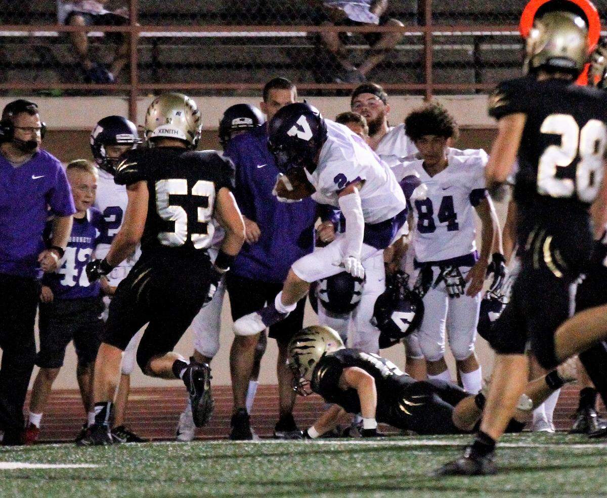 Valley Center senior receiver Blayne Hightower hurdles a defender in the Hornets’ 27-17 loss to Andover Central on Thursday. (Sept. 20, 2018)