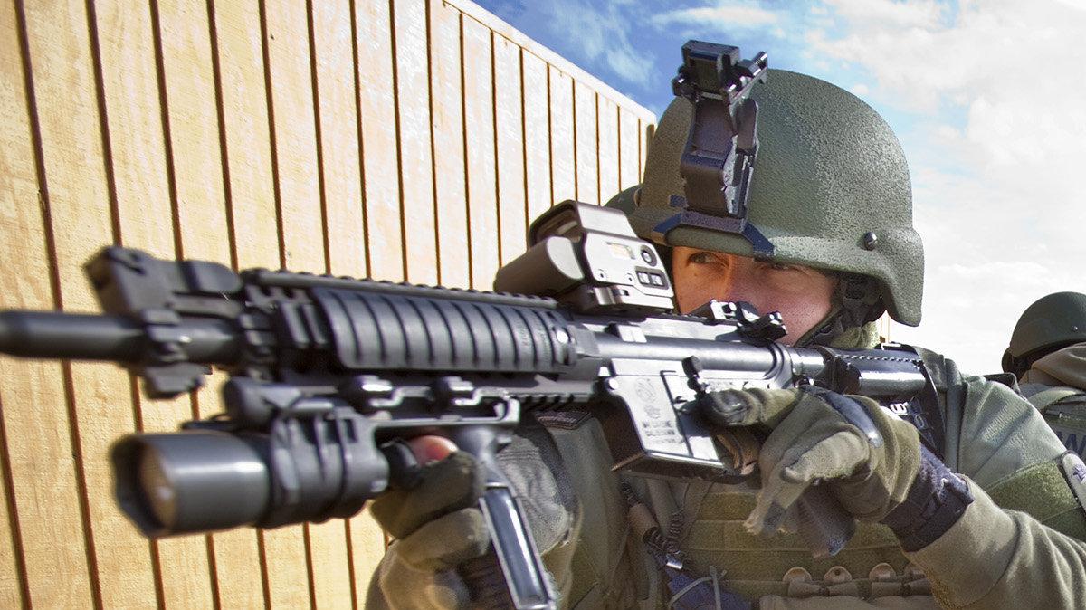 Wichita Police SWAT officers train for wounded officer retrieval under fire using the department's new Ballistic Armored Tactical Transport vehicle at the Wichita Sedgwick County Firearms Training Facility Wednesday, Oct. 26, 2011.