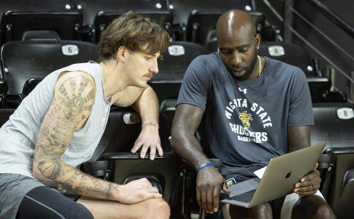WSU assistant coach Quincy Acy, a former NBA big man, has become a mentor to the group of centers, including Jacob Germany (left), on the Shockers.