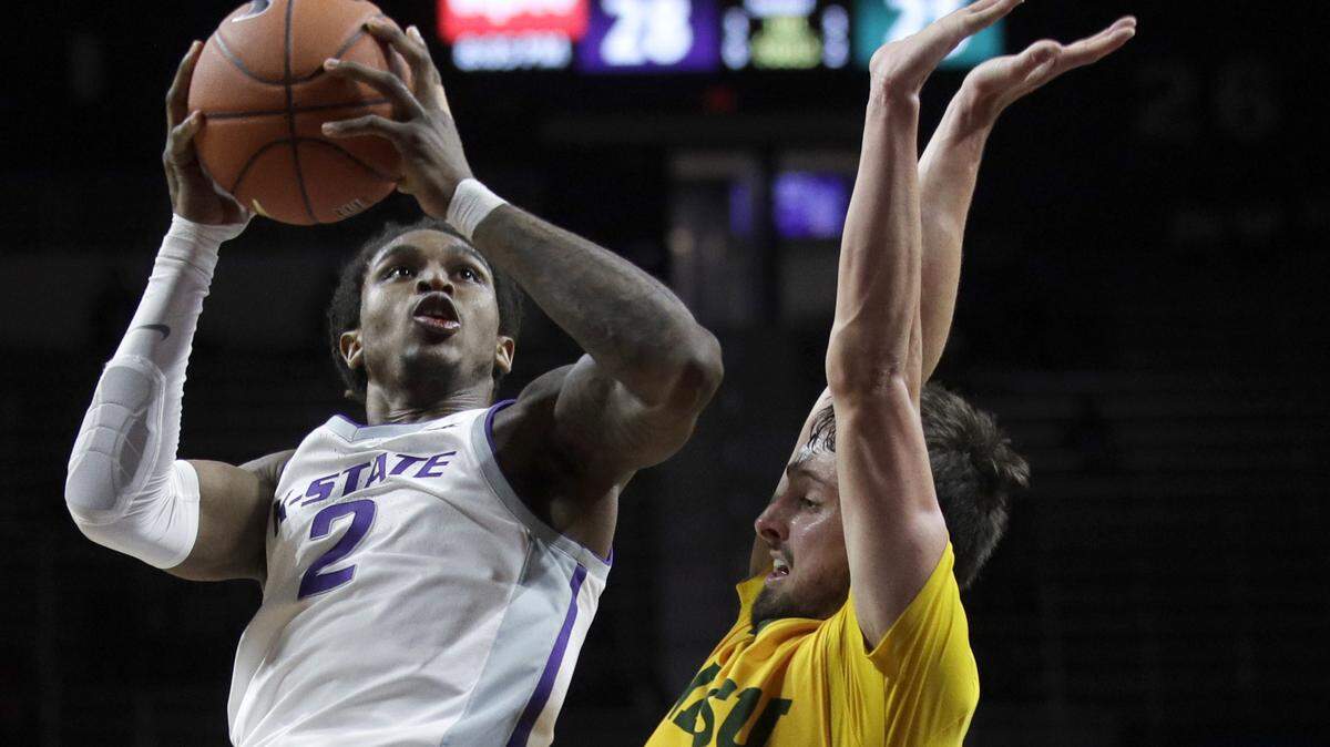 Kansas State guard Cartier Diarra (2) shoots while covered by North Dakota State guard Jared Samuelson, right, during the second half of an NCAA college basketball game in Manhattan, Kan., Tuesday, Nov. 5, 2019. (AP Photo/Orlin Wagner)