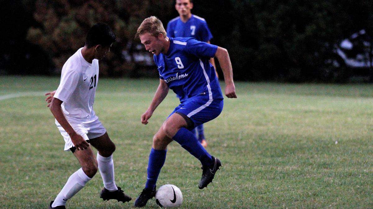 Kapaun senior midfielder Jack Barrier, in action earlier this season against Carroll and forward Michael Ibarra-Silva, defeated Wichita Heights 3-1 Tuesday in a playoff match.