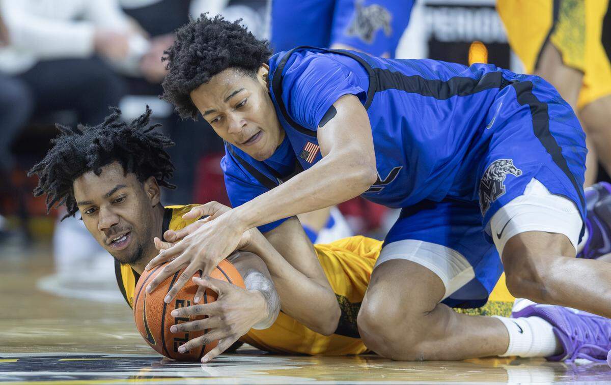 Wichita State’s Dillon Battie comes up with a loose ball against Memphis’ William Whorton during the first half at Koch Arena on Saturday.