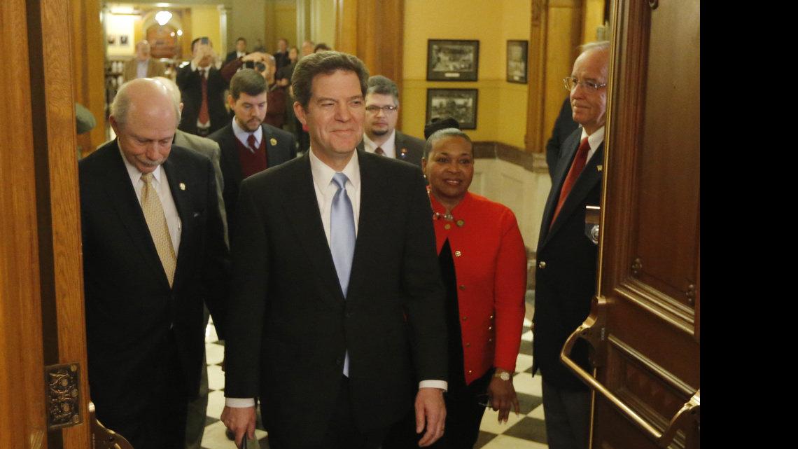 Gov. Sam Brownback is announced Tuesday night prior to the State of the State address. Accompanying the governor was Sen. Oletha Faust-Goudeau (right) and Sen. Les Donovan. (Jan. 15, 2013)