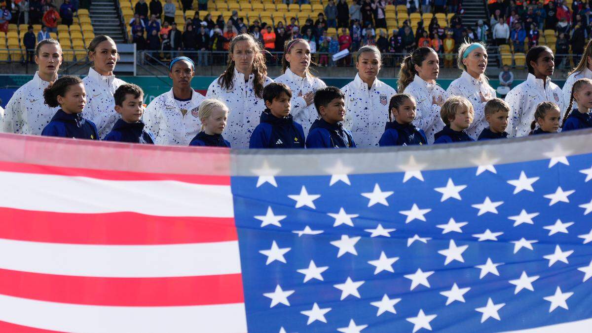 The USA women’s World Cup team stands for the National Anthem before their game against the Netherlands Thursday. The team’s under fire from right-wing media and politicians because not all the players sang along or put their hand over their heart.