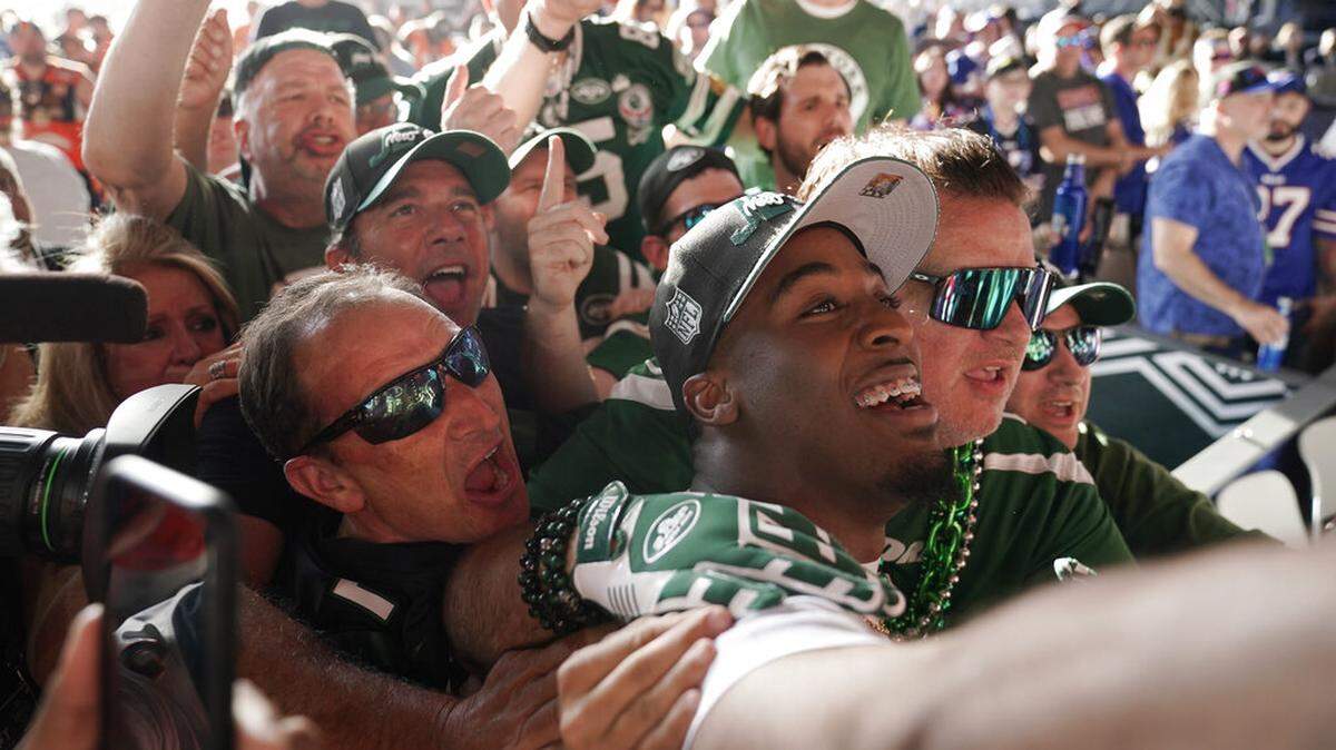 Iowa state running back Breece Hall takes selfies with fans after being selected by the New York Jets during the second round of the NFL football draft Friday, April 29, 2022, in Las Vegas. (AP Photo/Jae C. Hong)