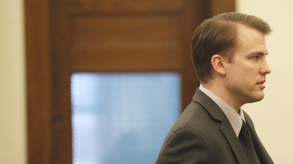 Brett Seacat leaves the courtroom during the noon recess.  Seacat is charged with first-degree murder, aggravated arson and two counts of aggravated child endangerment. He maintains his wife set fire to their Kingman home and then killed herself. He made it out of the two-story house with the coupleÕs 2- and 4-year-old sons. (November 30, 2011)