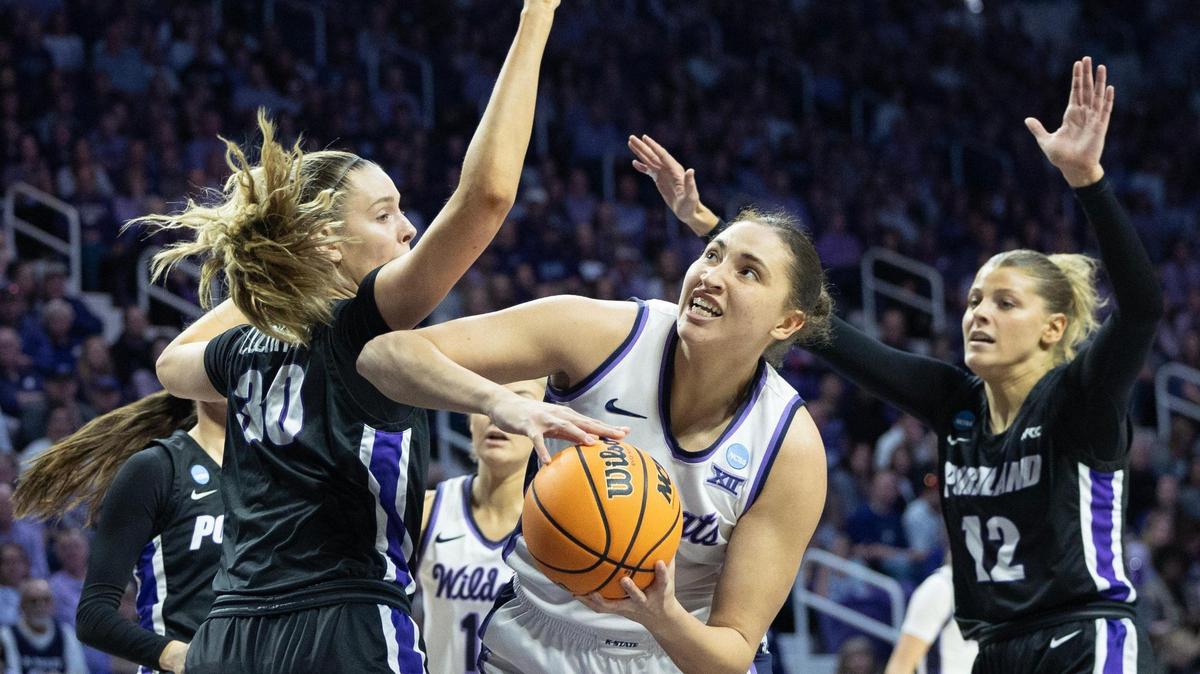 Kansas State’s Ayoka Lee looks to the basket between Portland defenders Lucy Cochrane, left, and Kennedy Dickie, right, during the first quarter of their NCAA Tournament game on Friday, March 22, 2024, in Manhattan.
