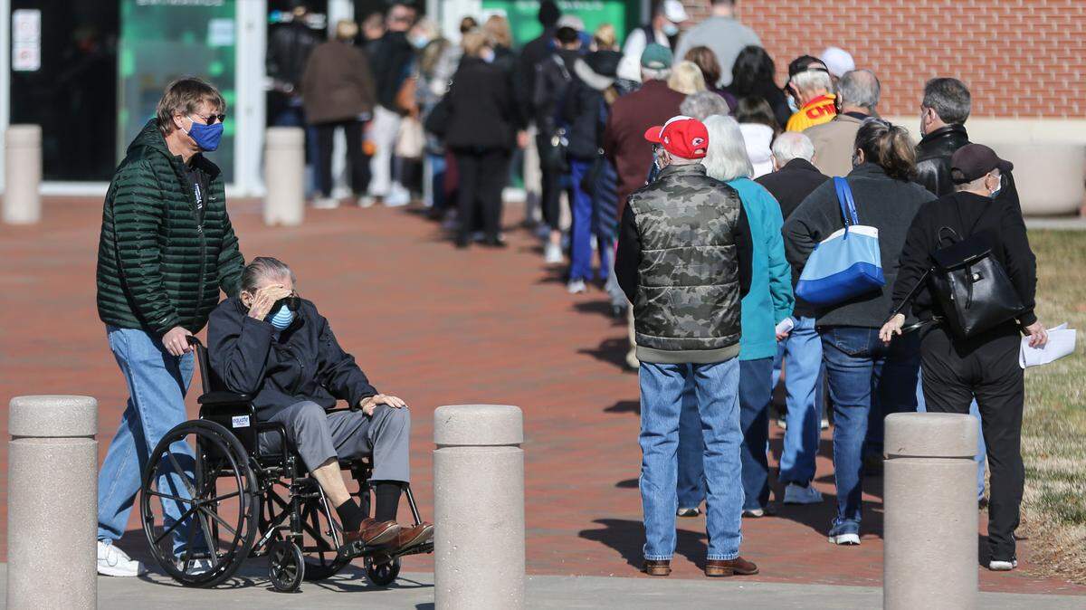 People line up outside of Intrust Bank Arena on Feb. 1 for a by-appointment coronavirus vaccination clinic. Currently, health care works and residents over the age of 80 are eligible for the vaccine.