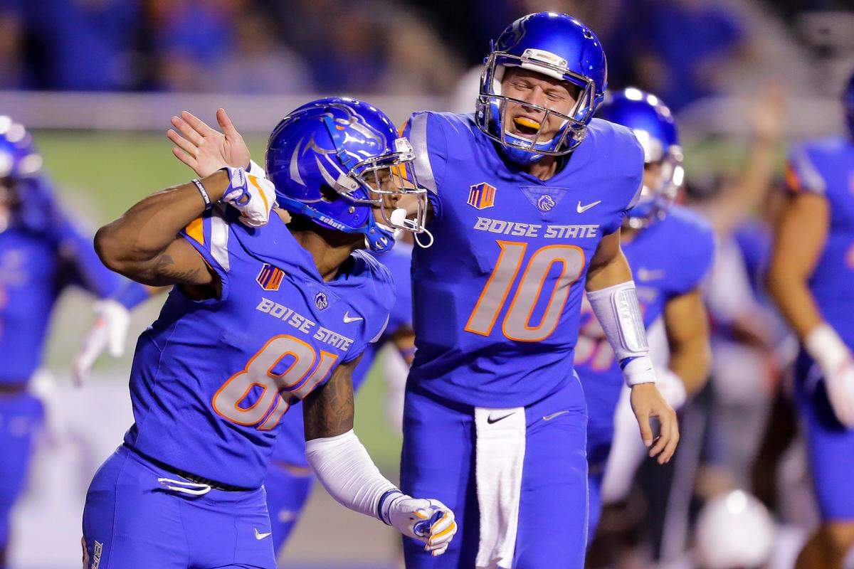 Boise State quarterback Chase Cord (10) celebrates with Boise State wide receiver Akilian Butler (81). (AP Photo/Steve Conner)