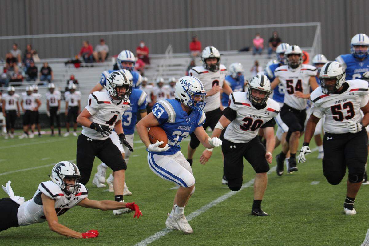 Early in the first quarter, Kapaun Mt. Carmel senior Cale Curtis busts through the Emporia defense for a 15-yard gain on senior night Sept. 17 at Stryker Sports Complex. The play would set up the second of eight touchdowns on the night en route to a 56-13 throttling of the Spartans.