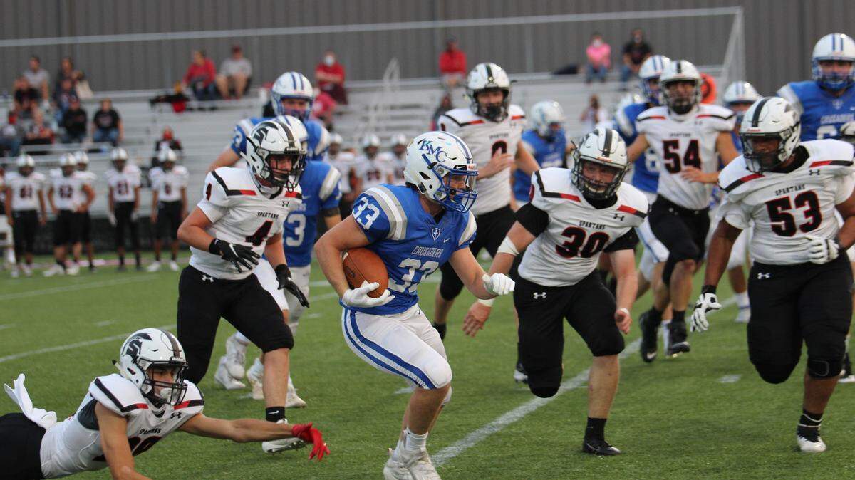 Early in the first quarter, Kapaun Mt. Carmel senior Cale Curtis busts through the Emporia defense for a 15-yard gain on senior night Sept. 17 at Stryker Sports Complex. The play would set up the second of eight touchdowns on the night en route to a 56-13 throttling of the Spartans.