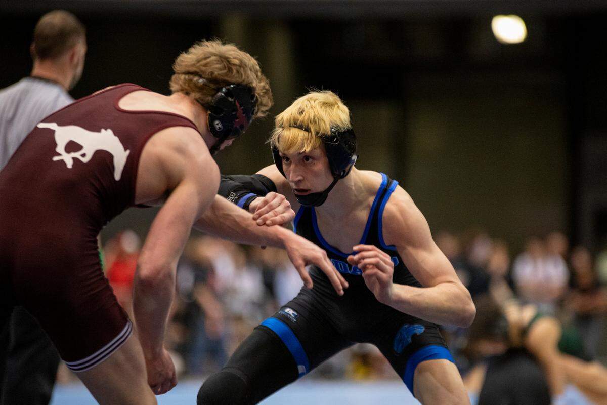 Goddard sophomore Kolton McElwain grapples with Salina Central’s Jase Adam in the 126-pound finals at the Class 5A state wrestling tournament at Hartman Arena on Saturday.