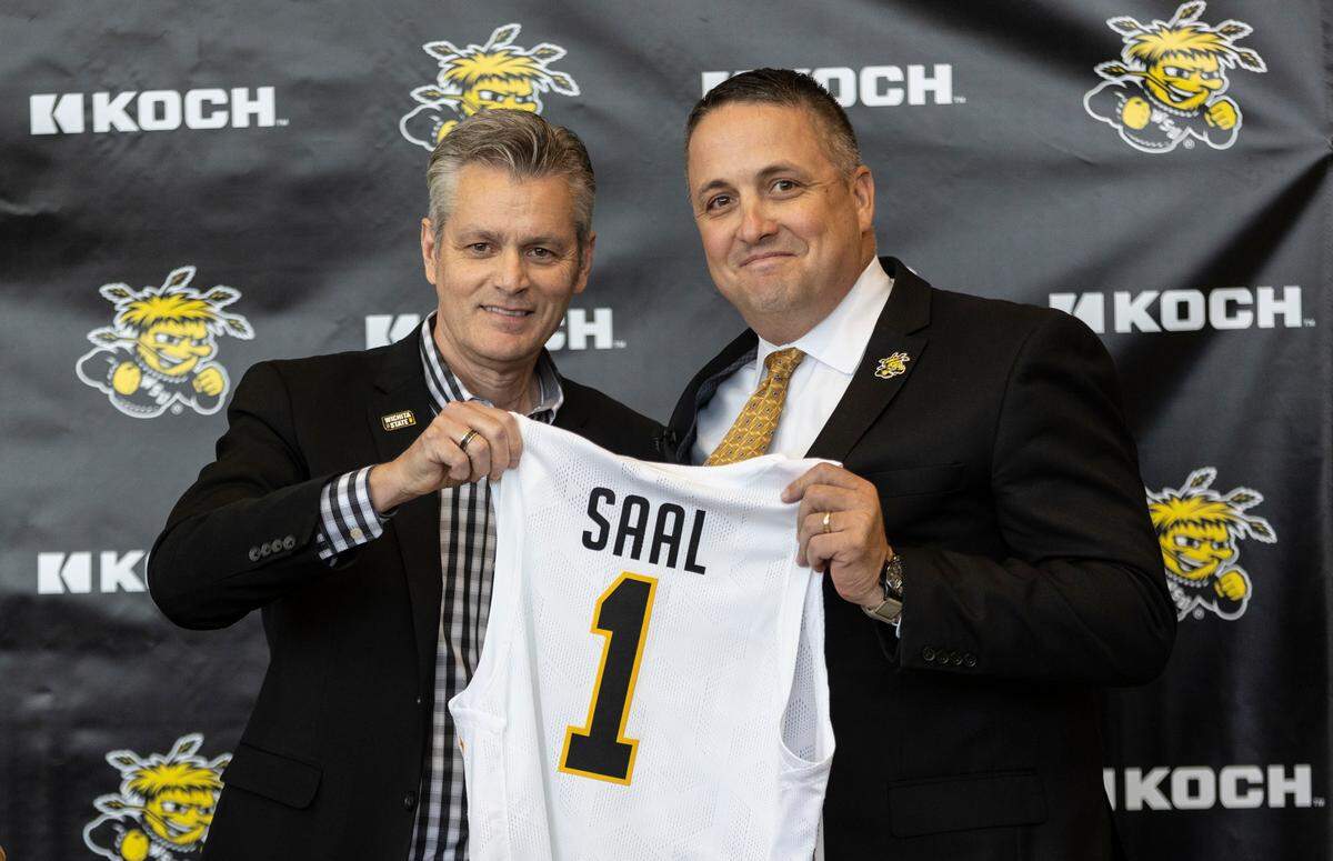 Wichita State president Rick Muma introduces new athletic director Kevin Saal during a press conference at Koch Arena.