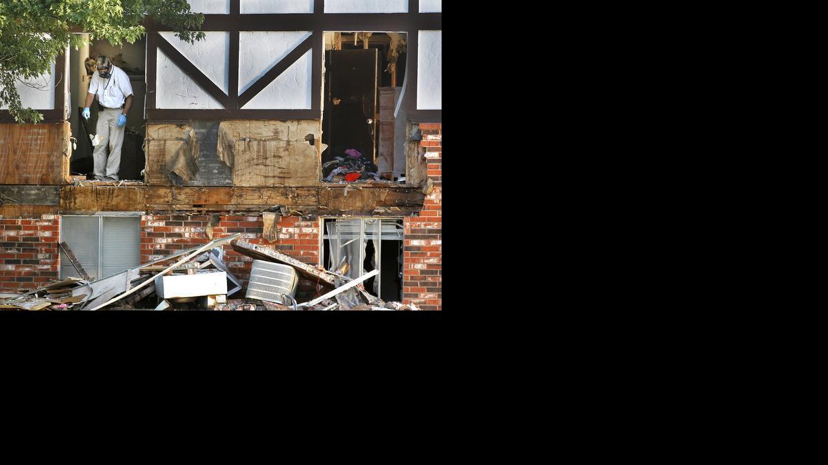 Police investigators go through the apartment that Jared Woosypiti holed up in at Southlake Village during a standoff. (July 12, 2013)

