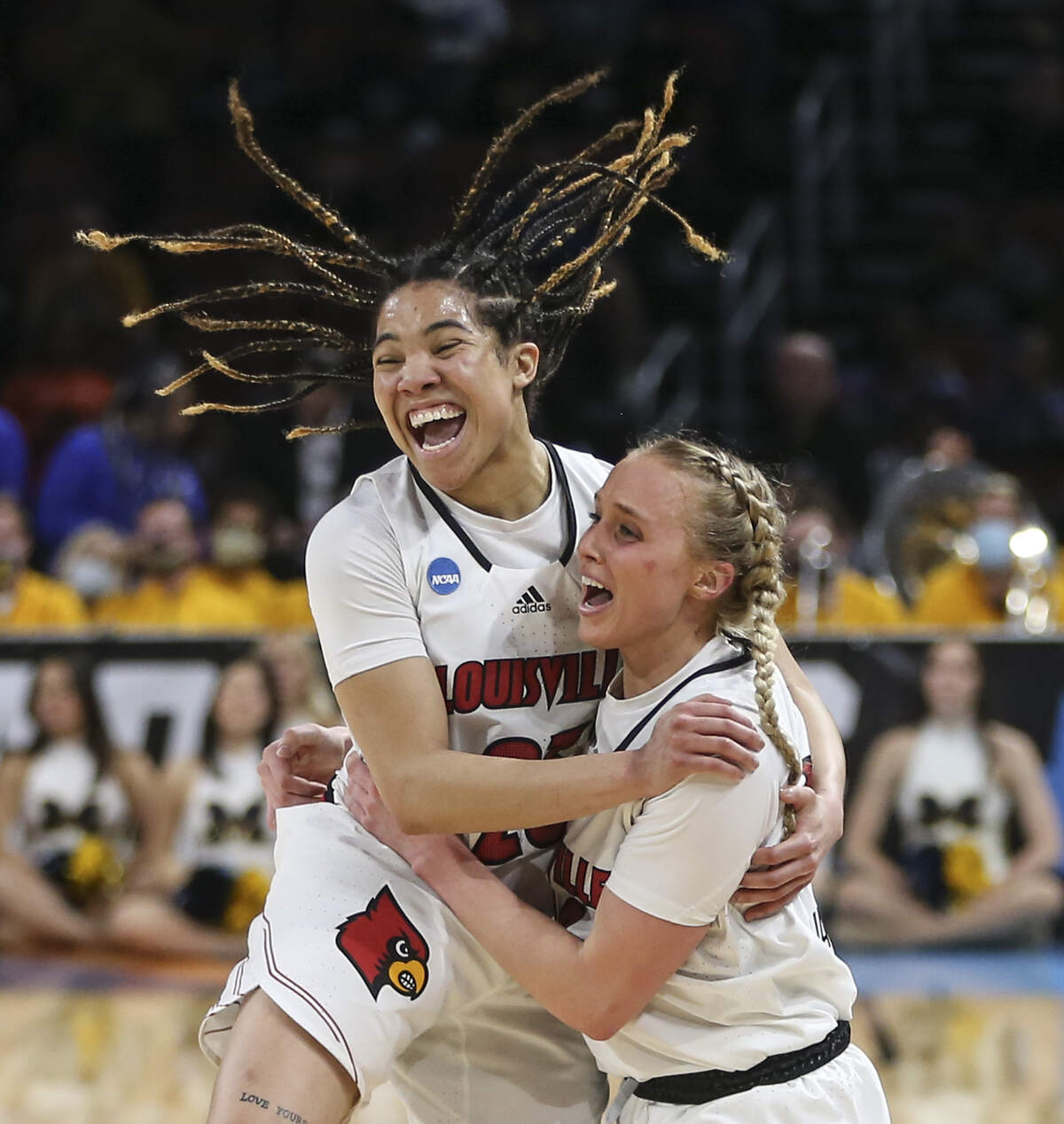 Louisville’s Hailey Van Lith, right, celebrates with teammate Chelsie Hall after the Cardinals wrapped up a spot in the Final Four with a win over Michigan last season. Van Lith leads the Cardinals this season with an average of 20.0 points per game.