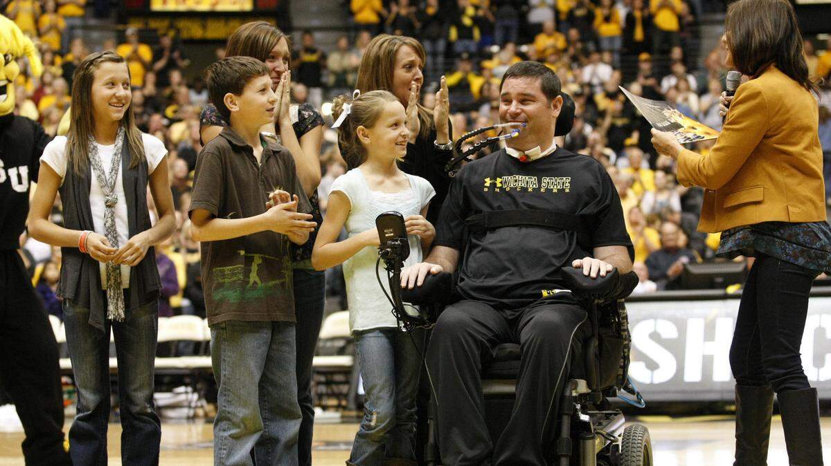 The Carl Hall family reacts to receiving full scholarships for their four children at WSU at Koch Arena in 2011 in a ceremony that also inducted Hall into the WSU Hall of Fame. (Feb. 18, 2011)