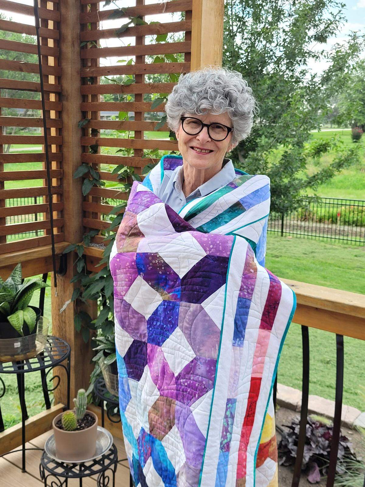 Dottie Evans of White Crane Designs said she pieced this Fossil Fern fabric on a 1937 Singer Featherweight machine and finished it on a 2023 Handi Quilter Amara. “I always wanted to make a quilt using this fabric line, which was popular about 15 years ago. When there was a rerun of the fabric, I took advantage of making a quilt just for me.” She named it “Finally Fossil Fern” since she finally got the material.