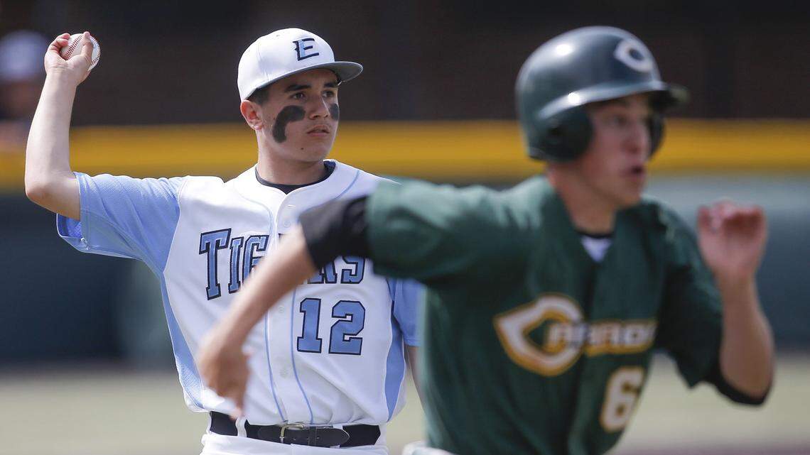 Goddard Eisenhower pitcher Braden Minor throws out Bishop Carroll baserunner John Buchanan on Thursday afternoon at Eck Stadium. (May 23, 2013)