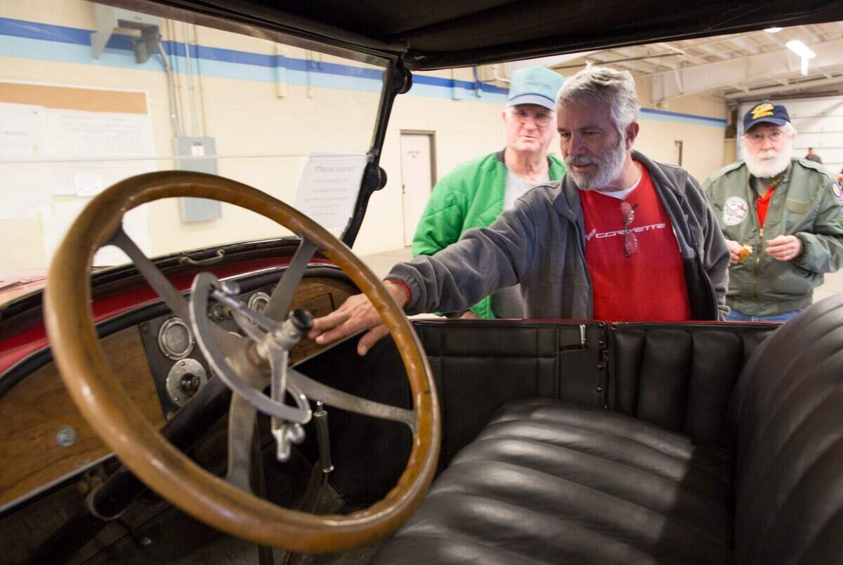 Jim Zorn, from left, Ross Stanley and Gene White look over a 1919 Jones Six at the Kansas Sunflower Swap Meet at the Kansas Coliseum Pavilions in 2017.