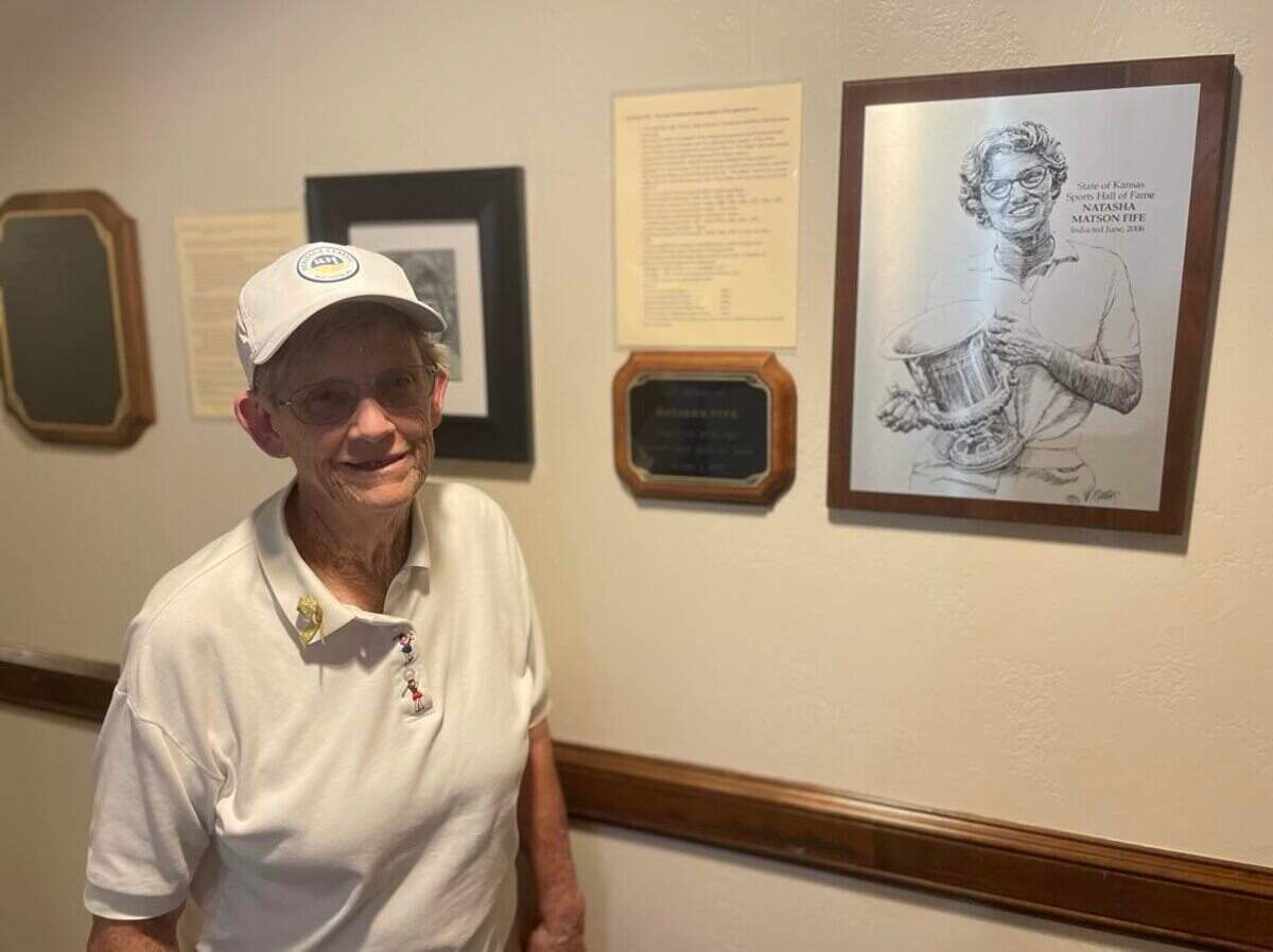 Natasha Fife, a Wichita women’s golf legend, poses next to her plaque inside Rolling Hills, which was the birthplace of the LPGA dating back to 1950.