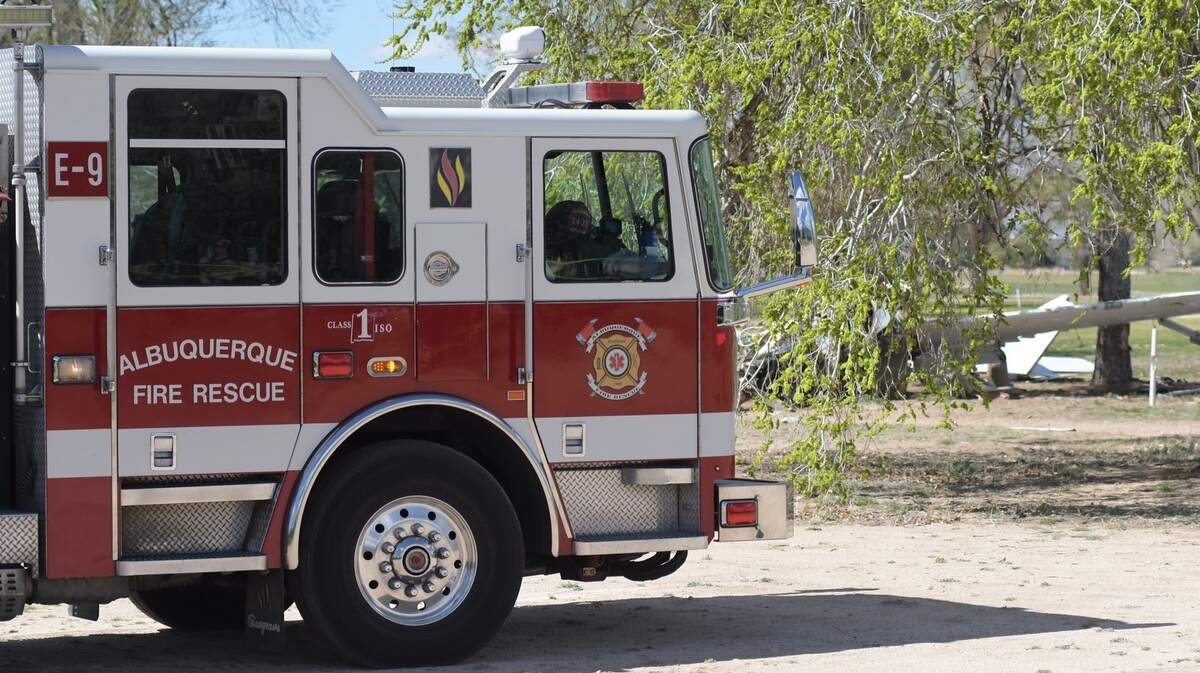 Albuquerque Fire Rescue shared this photo on social media that shows a plane crashed in the background. One person died and another was critically injured in the crash.