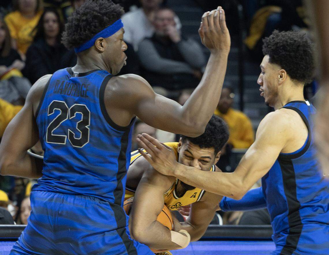 Wichita State’s Harlond Beverly gets trapped by Memphis defenders Malcolm Dandridge, left, and Jahvon Quinerly, right during the first half on Sunday at Koch Arena.