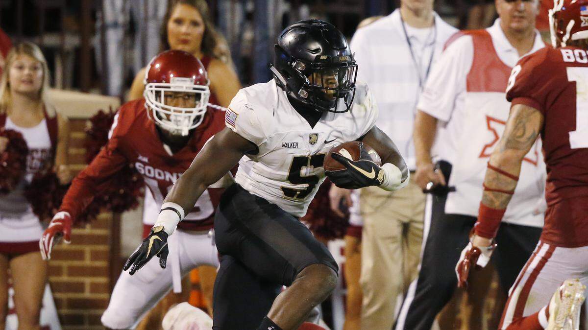 Army running back Kell Walker (5) carries during an NCAA college football game between Army and Oklahoma in Norman, Okla., Saturday, Sept. 22, 2018. (AP Photo/Sue Ogrocki)