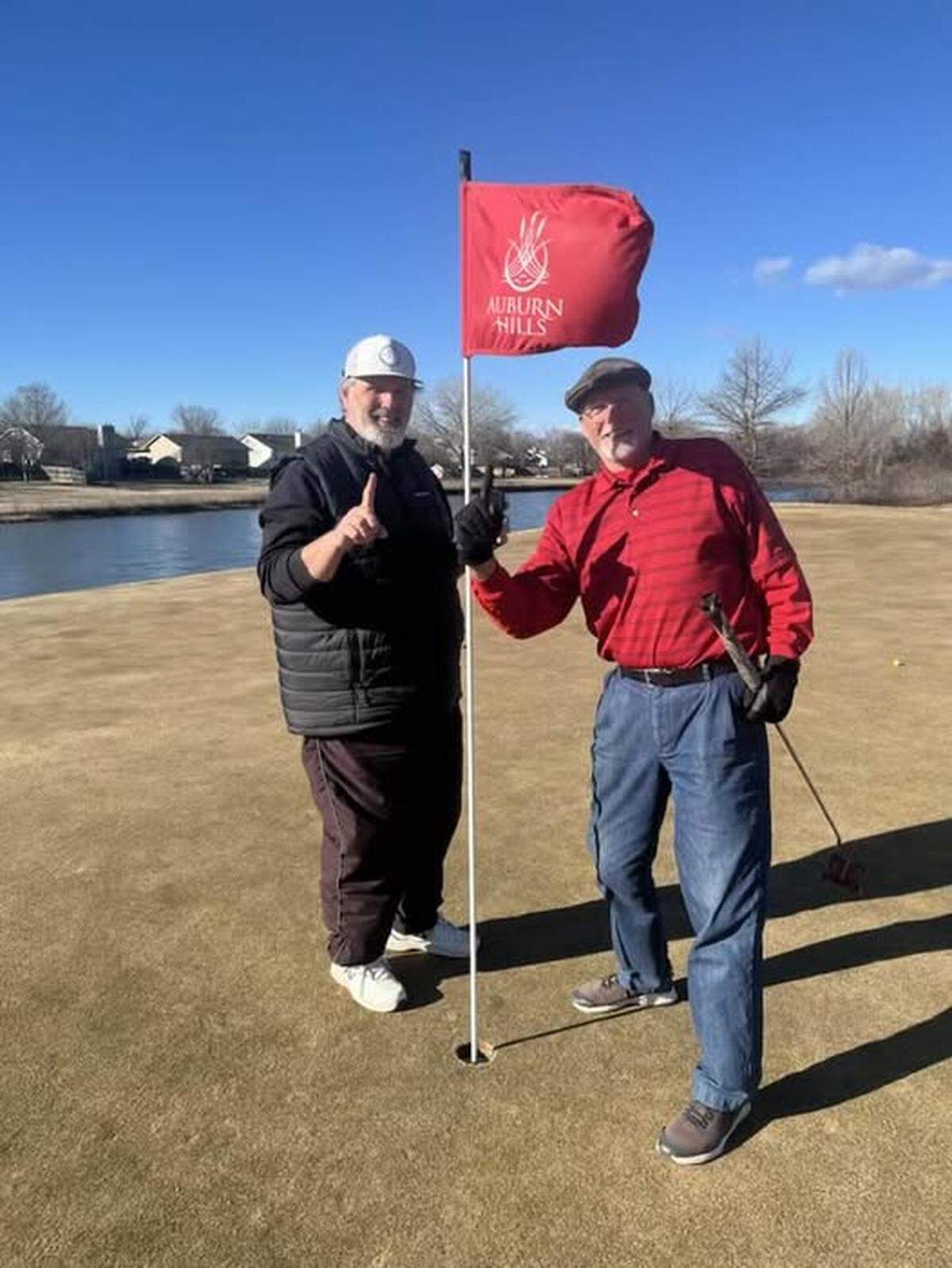 Leroy Leep, left, and Mike McMillin celebrate their holes-in-one at hole No. 4 at Auburn Hills on Sunday.