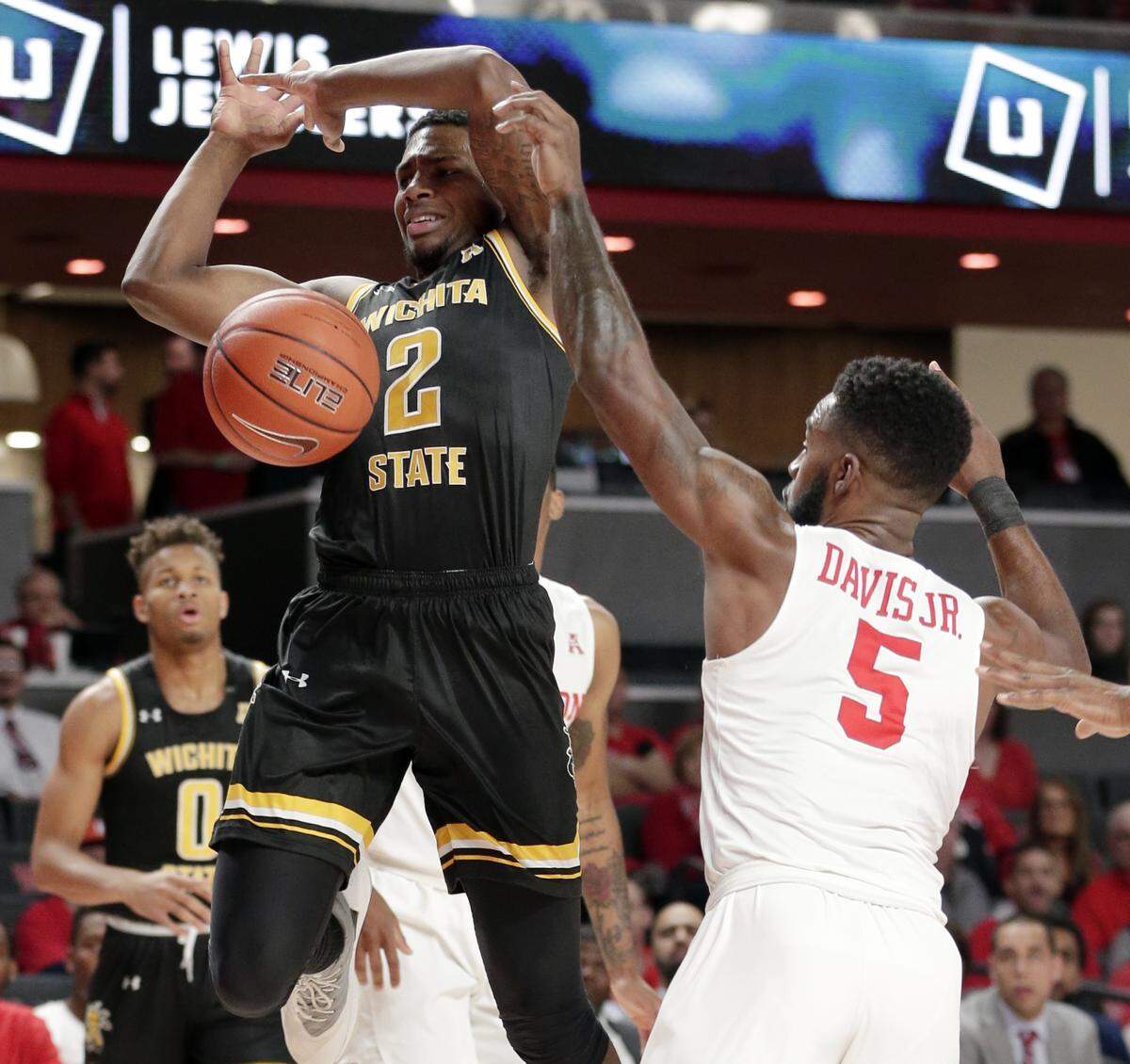 Wichita State guard Jamarius Burton (2) loses the ball as he goes up for a shot under pressure from Houston guard Corey Davis Jr. (5) during the first half of an NCAA college basketball game Saturday, Jan. 12, 2019, in Houston. (AP Photo/Michael Wyke)
