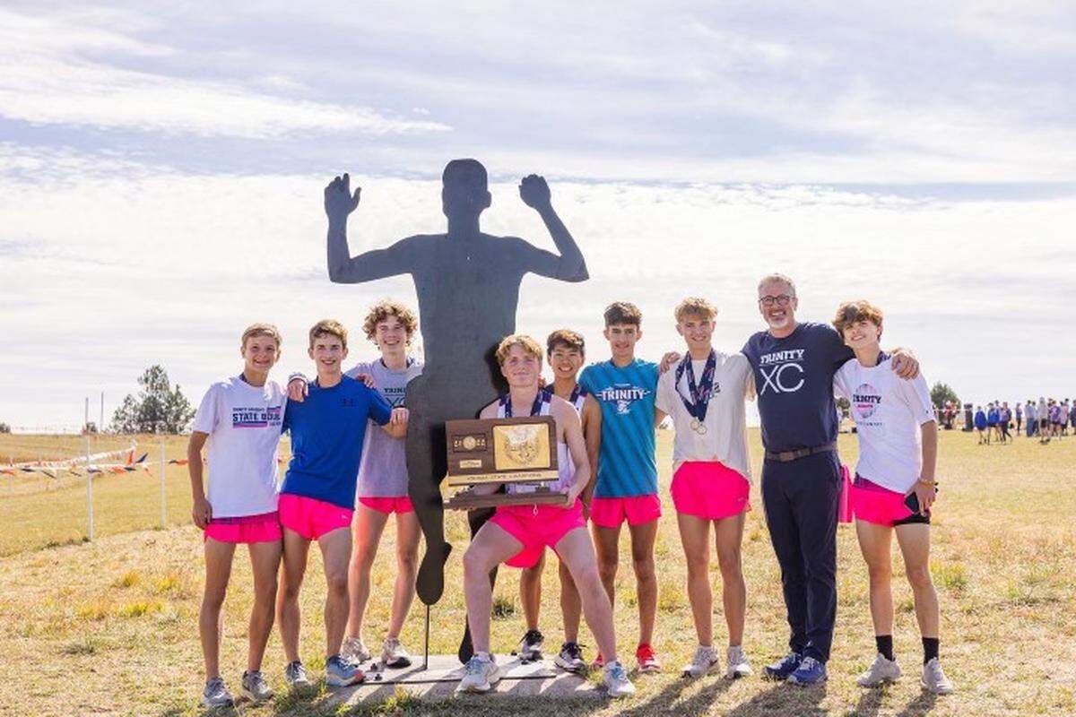 Trinity Academy senior Ian Carroll (holding trophy) helped recruit many of the runners who helped the Knights win their second straight team state title this past weekend.