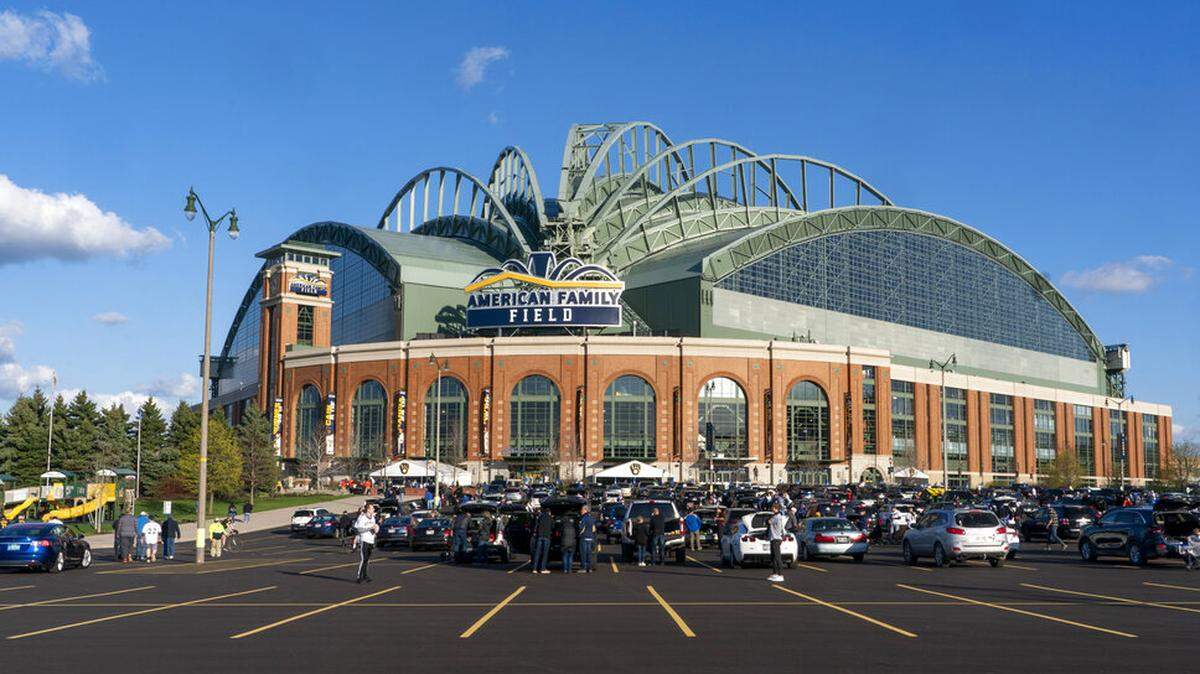 Fans are seen outside American Family Field before a baseball game between the Milwaukee Brewers and the Chicago Cubs Monday, April 12, 2021, in Milwaukee. (AP Photo/Morry Gash)