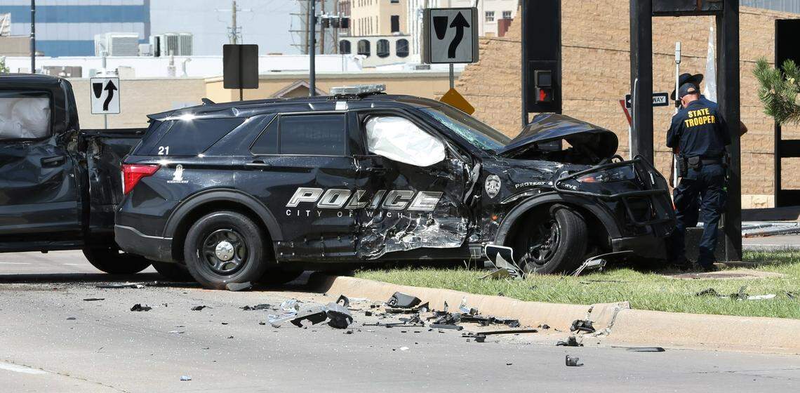 Debris dotted along Main street from a two-vehicle wreck involving a Wichita police patrol vehicle and pickup truck on Saturday near Downtown Wichita.