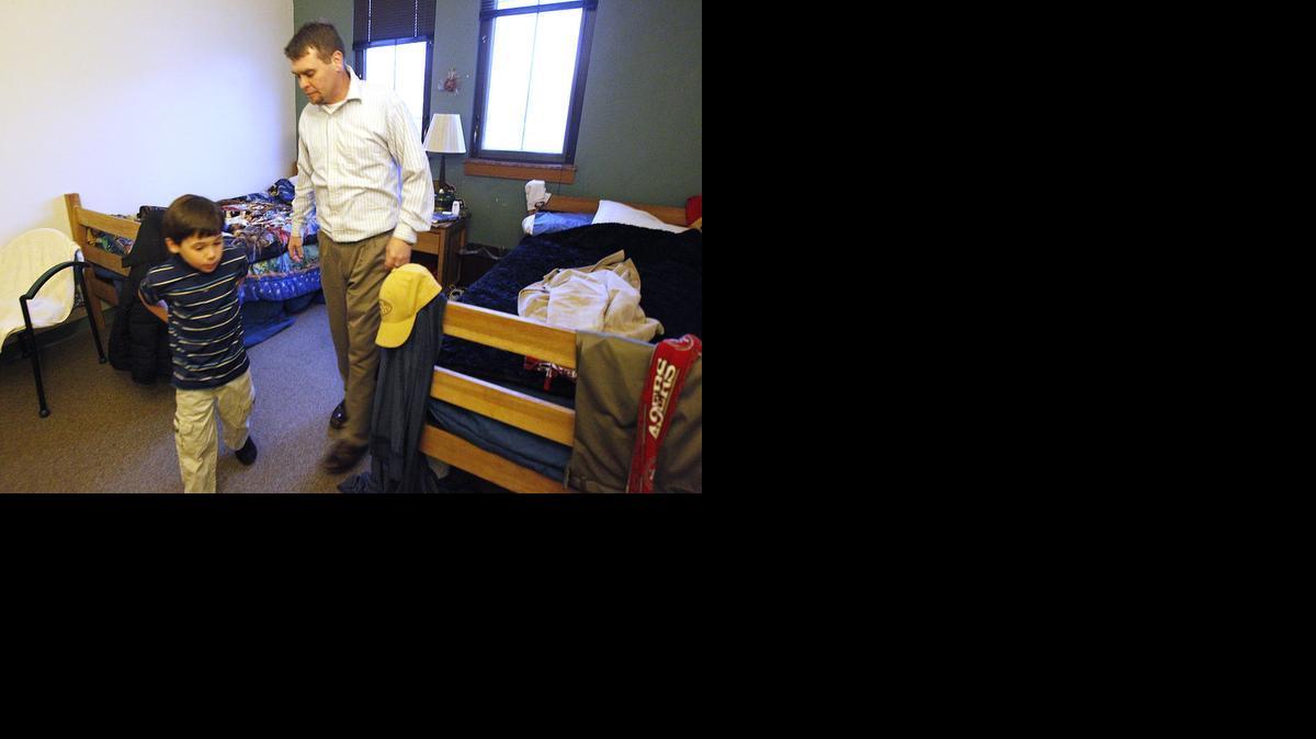 Ryan Shelton and his son Gavin, 8, get back to their room after taking a walk to the local Quiktrip. Unseasonably warm weather allowed them to get out for a walk. (Jan. 8, 2013)

